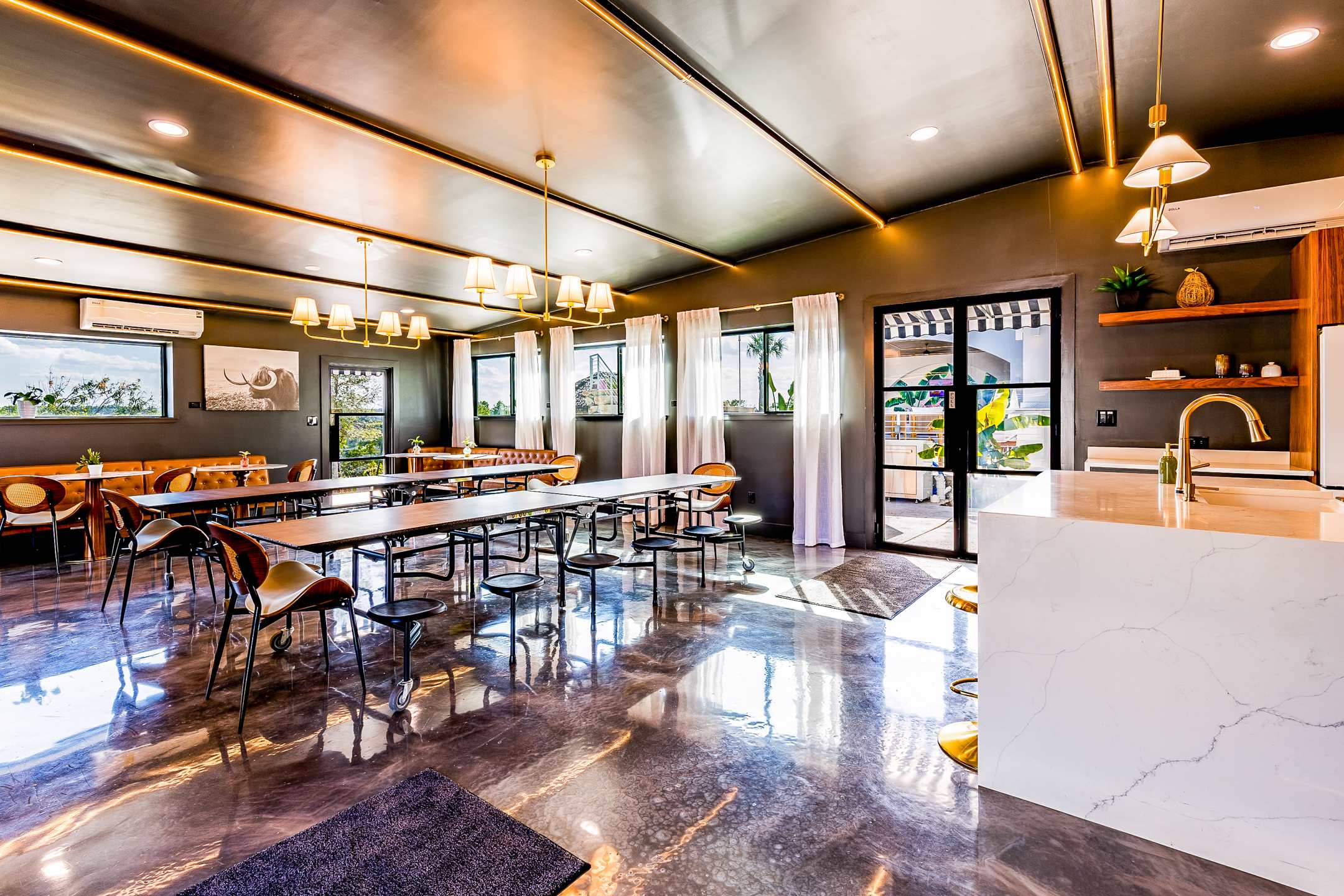 Dining hall and chef's kitchen with seating for the full group